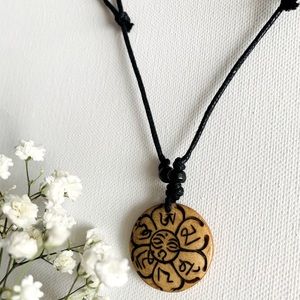 Bone mantra pendant on adjustable cord